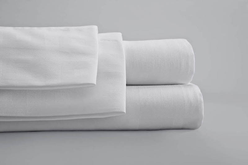 Crisp white hospitality linens from Standard Textile are the best sheets for short term rentals