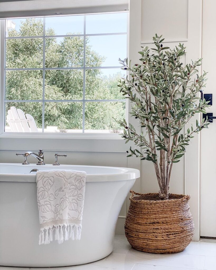 Six-foot artificial olive tree from Nearly Natural in an airy bathroom, adding natural texture and elevating the space
