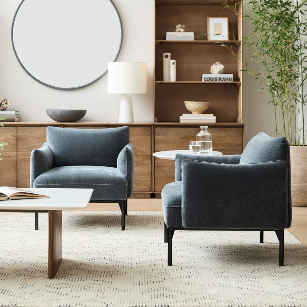 Modern chenille Penn chairs from West Elm, showcasing sleek lines and a high-end look in this Airbnb living room
